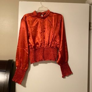 Beautiful rust colored blouse with scrunch bottom and key - hole back.